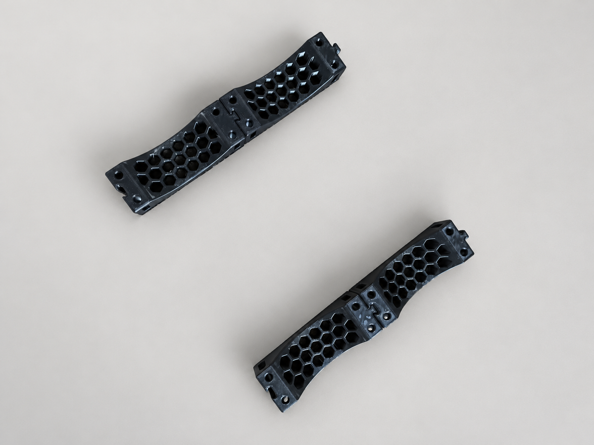 Four black ABS cradle pieces connected as two parallel rows on a neutral surface. This image shows TWO SETS for supporting two cylinders; a single $24.95 set contains only two pieces for one cylinder.